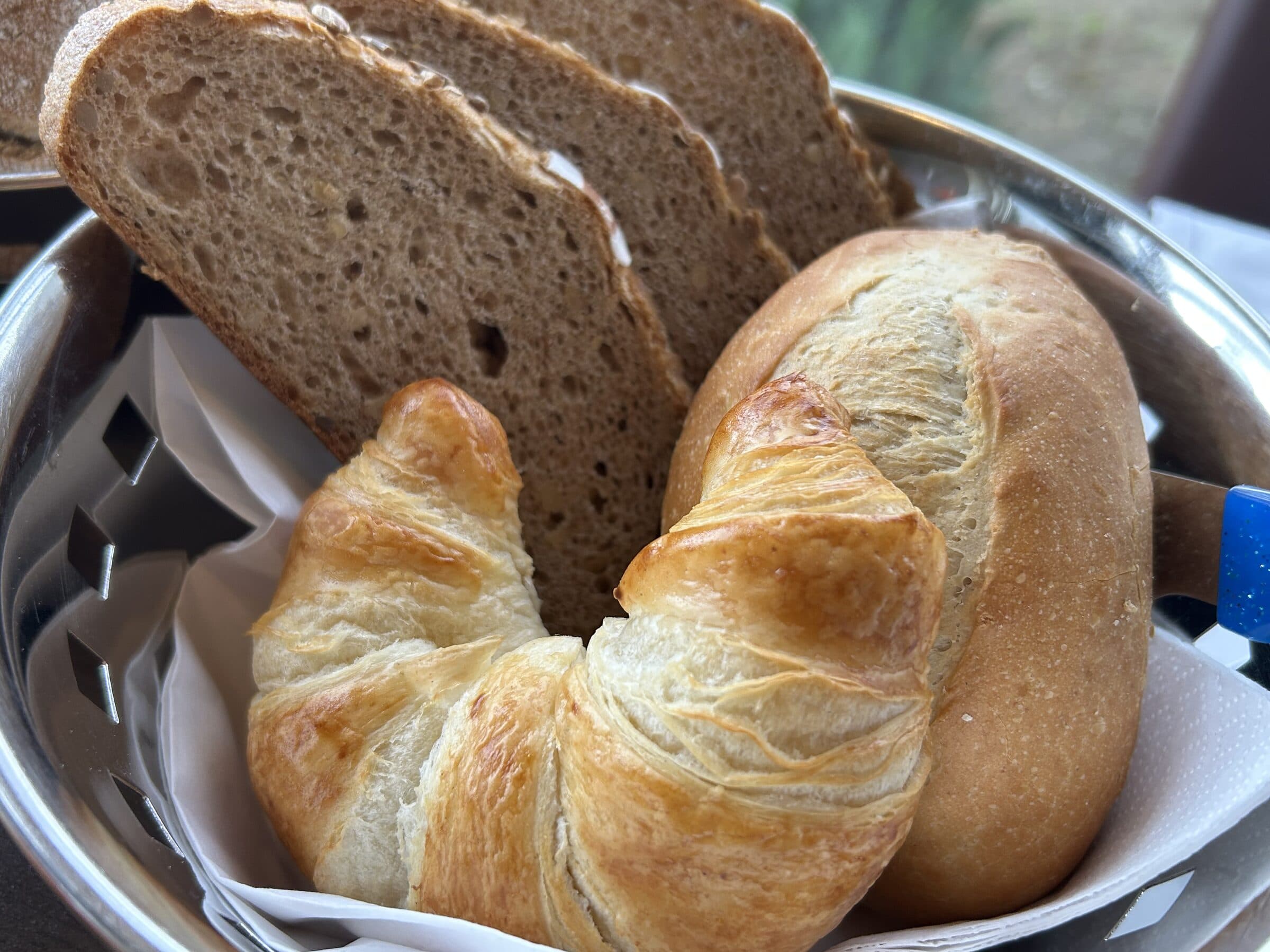Bread basket with croissant and country bread